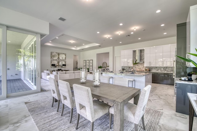 dining room with recessed lighting, a raised ceiling, visible vents, and marble finish floor