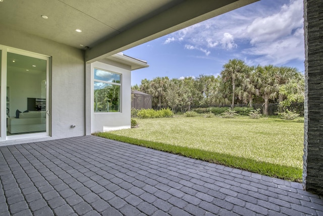 view of patio / terrace featuring glass enclosure and fence