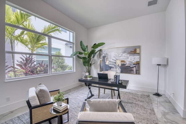 office space with marble finish floor, visible vents, and baseboards