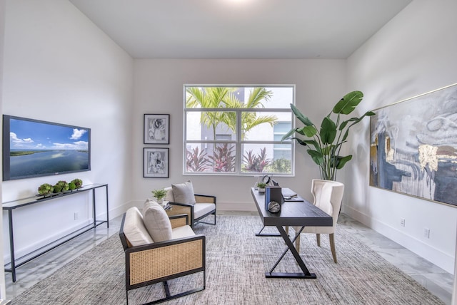 home office featuring marble finish floor and baseboards