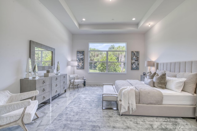 bedroom with a tray ceiling, marble finish floor, and recessed lighting