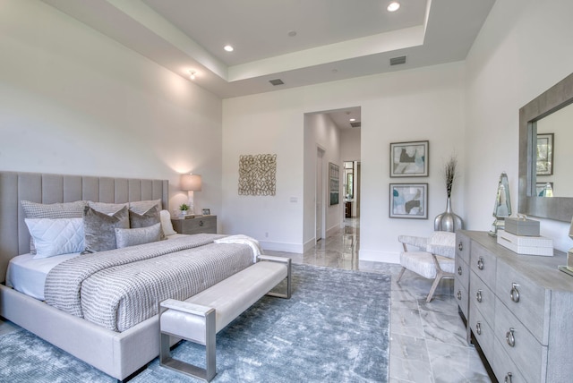 tiled bedroom with a raised ceiling