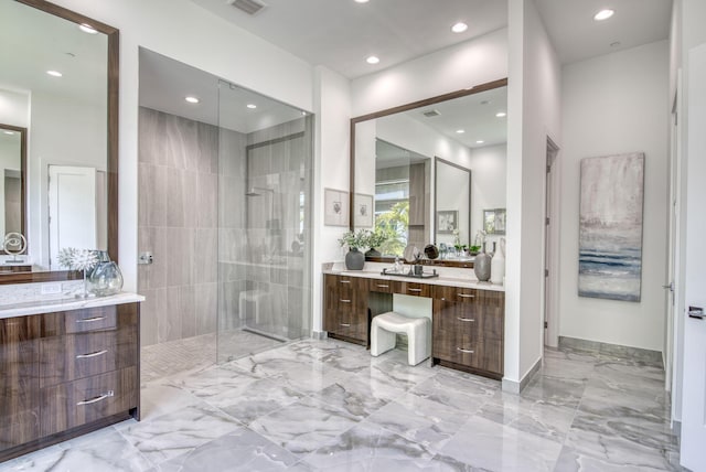 full bathroom with marble finish floor, recessed lighting, visible vents, vanity, and a walk in shower