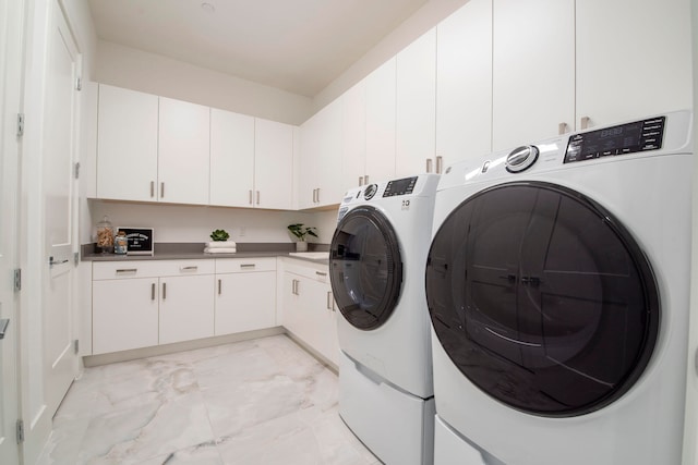 laundry room with cabinets, light tile patterned flooring, and independent washer and dryer