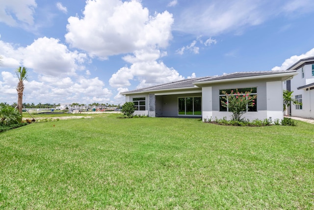 rear view of house with a yard