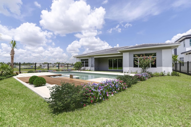 view of pool with a fenced in pool, fence, and a lawn