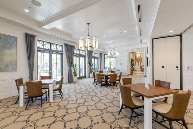 dining room with a notable chandelier, french doors, beamed ceiling, and ornamental molding