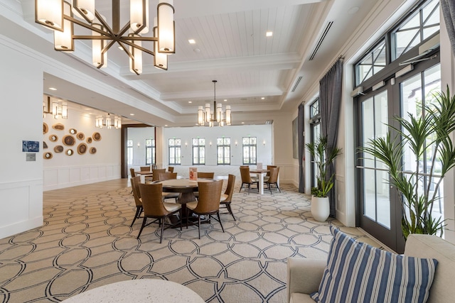 dining room featuring french doors, crown molding, a notable chandelier, a decorative wall, and wainscoting