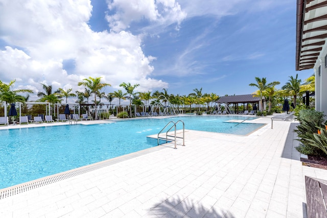 view of swimming pool featuring a patio and pool water feature