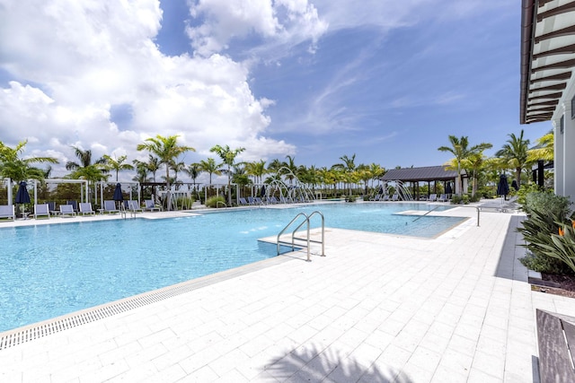 pool with a gazebo and a patio area