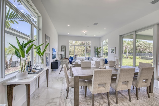 dining room with marble finish floor, visible vents, and recessed lighting