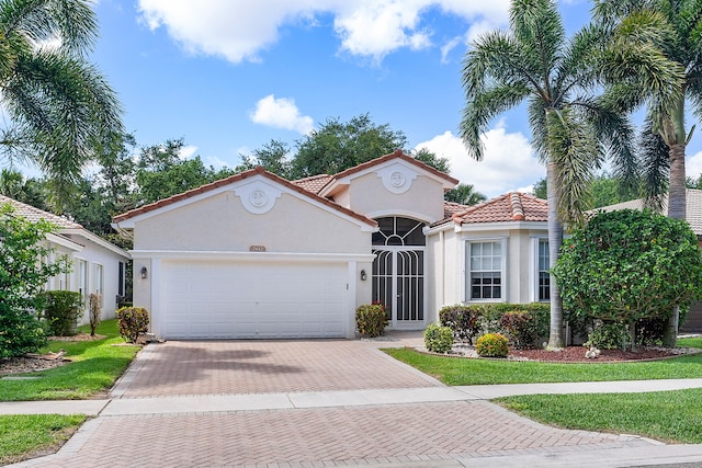 mediterranean / spanish-style home with a garage