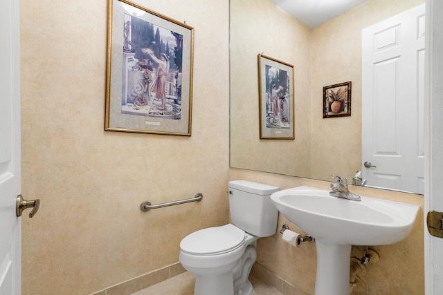 bathroom with tile flooring and toilet