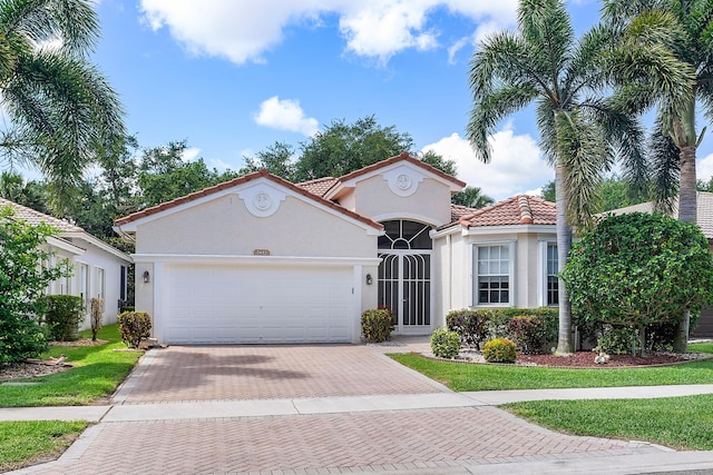 mediterranean / spanish-style house with a garage