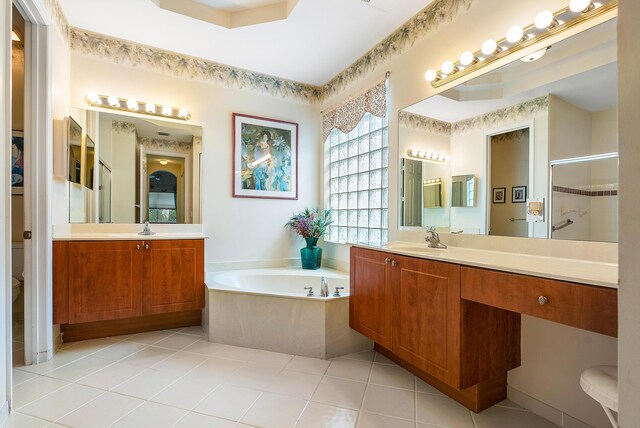 bathroom featuring vanity, tile floors, and a bathing tub