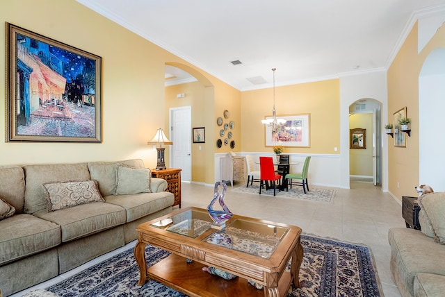 living room featuring a notable chandelier, crown molding, and light tile patterned flooring