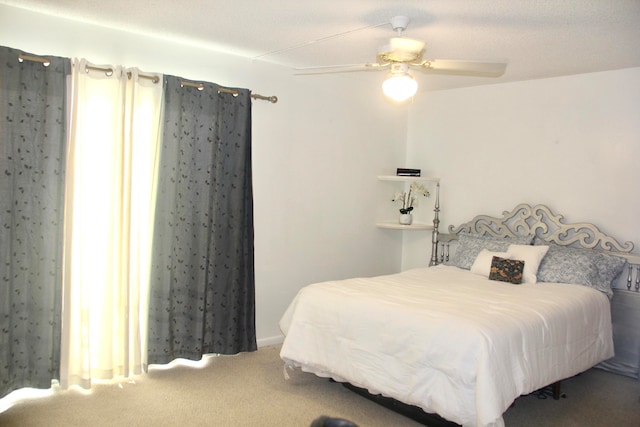 bedroom featuring ceiling fan and carpet