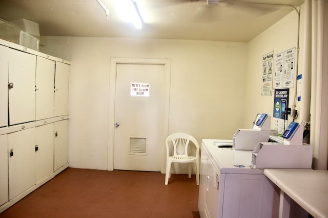 laundry area featuring separate washer and dryer and cabinets