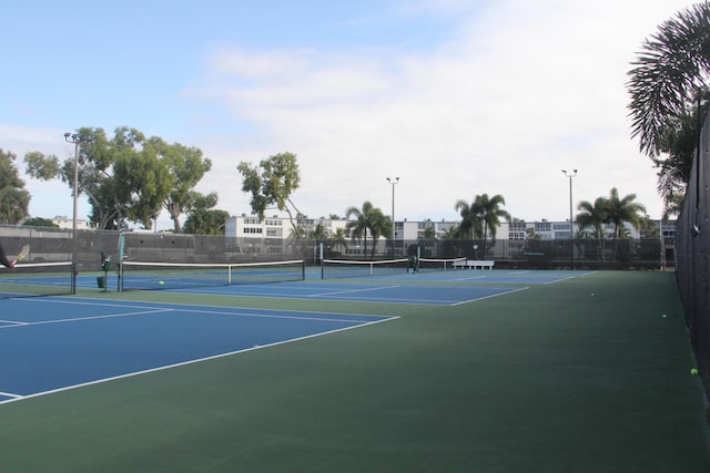 view of tennis court featuring basketball hoop