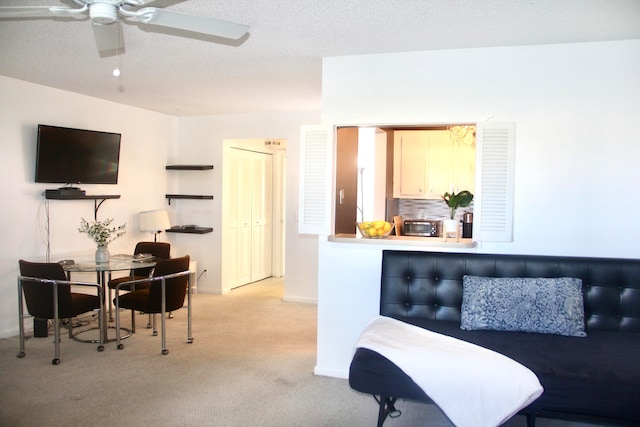 living room featuring a textured ceiling and light carpet