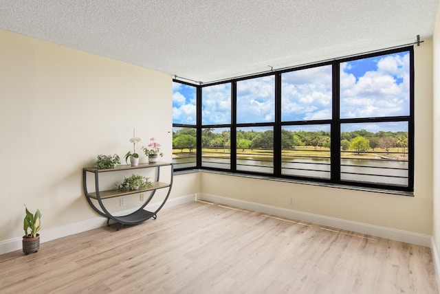 unfurnished sunroom featuring a water view