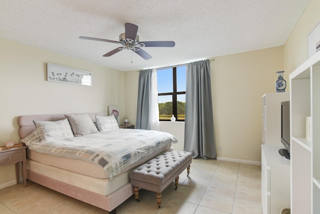 tiled bedroom with ceiling fan and a textured ceiling