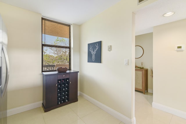 corridor featuring light tile patterned floors