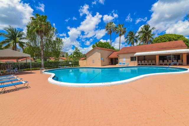 view of swimming pool with a patio