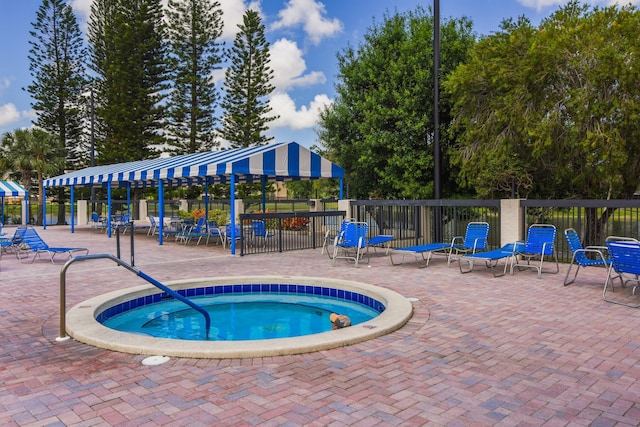 view of pool with a hot tub