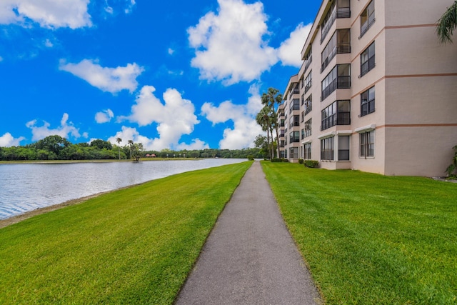 view of community featuring a lawn and a water view