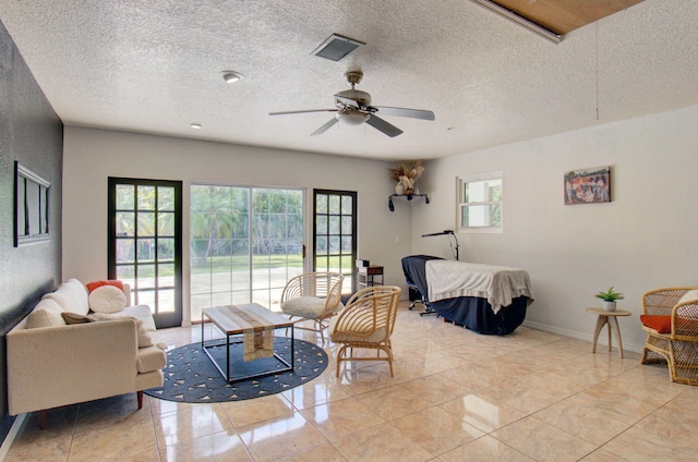 tiled bedroom with access to outside, ceiling fan, and a textured ceiling