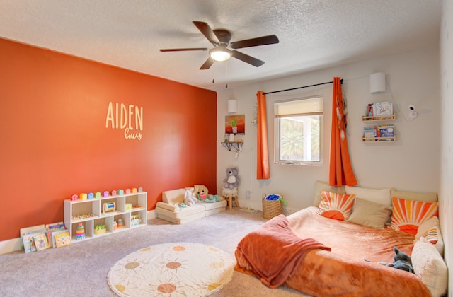 bedroom featuring a textured ceiling, ceiling fan, and carpet