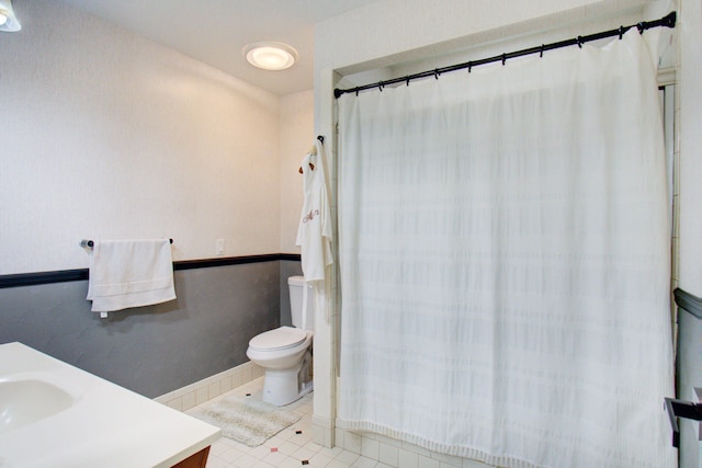 bathroom featuring tile patterned flooring, vanity, and toilet