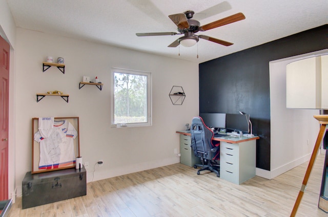 office space featuring ceiling fan, light wood-type flooring, and a textured ceiling