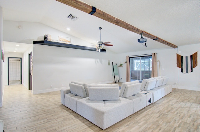 living room featuring vaulted ceiling with beams, ceiling fan, light hardwood / wood-style floors, and a textured ceiling