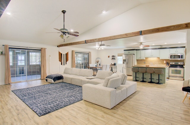 living room with light hardwood / wood-style flooring, ceiling fan, and lofted ceiling