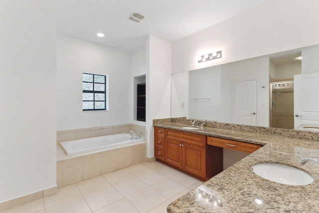 full bathroom with a garden tub, double vanity, tile patterned floors, and a sink