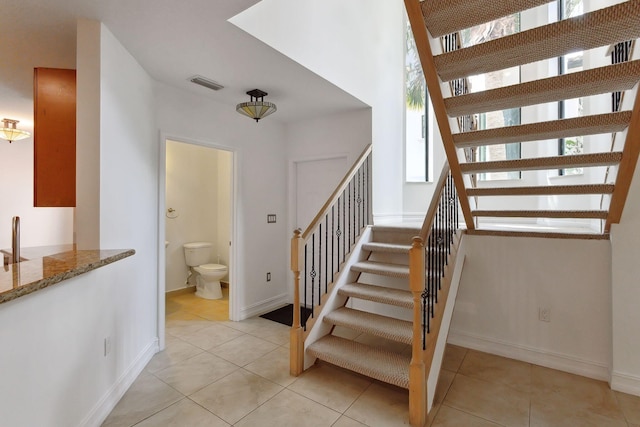 stairway featuring tile patterned flooring