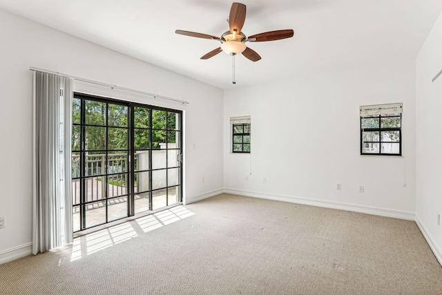 spare room with ceiling fan and light colored carpet