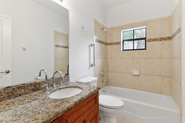 full bathroom with tile patterned floors, tiled shower / bath combo, vanity, and toilet