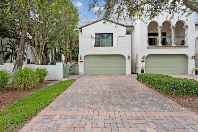 view of front of home with a balcony and a garage