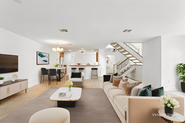 living room featuring a notable chandelier and light tile patterned flooring