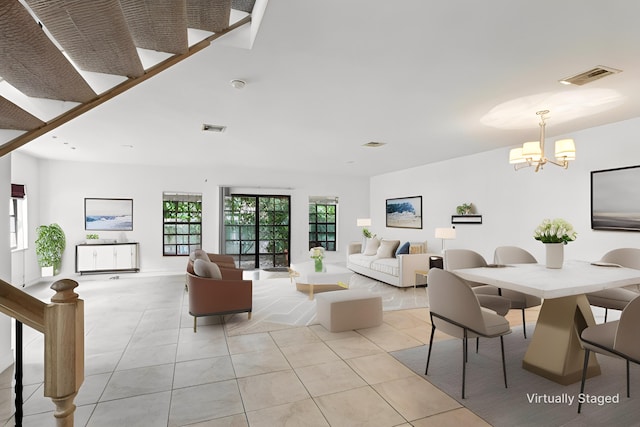 living room featuring an inviting chandelier, light tile patterned floors, and visible vents