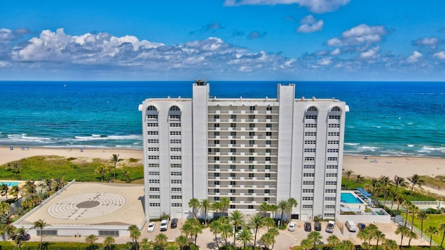 birds eye view of property featuring a beach view and a water view