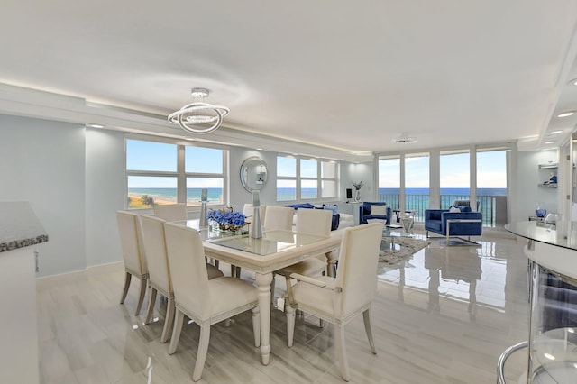 dining room with a water view and an inviting chandelier