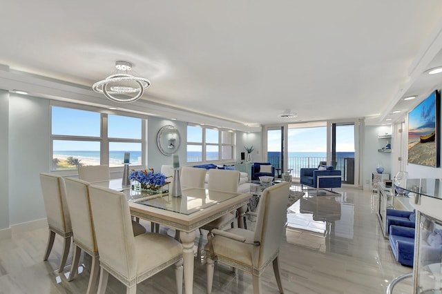 dining room featuring a water view and an inviting chandelier