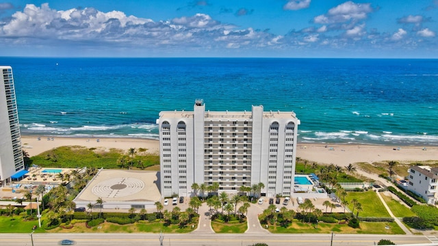 birds eye view of property featuring a beach view and a water view