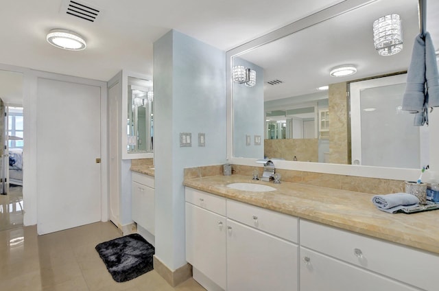 bathroom featuring large vanity and tile floors