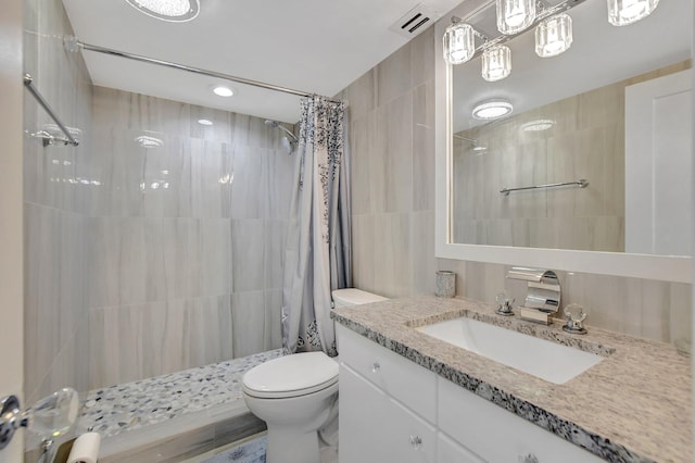 bathroom featuring walk in shower, toilet, and vanity