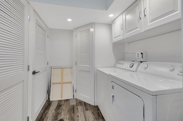 laundry room with cabinets, hardwood / wood-style floors, and washer and clothes dryer